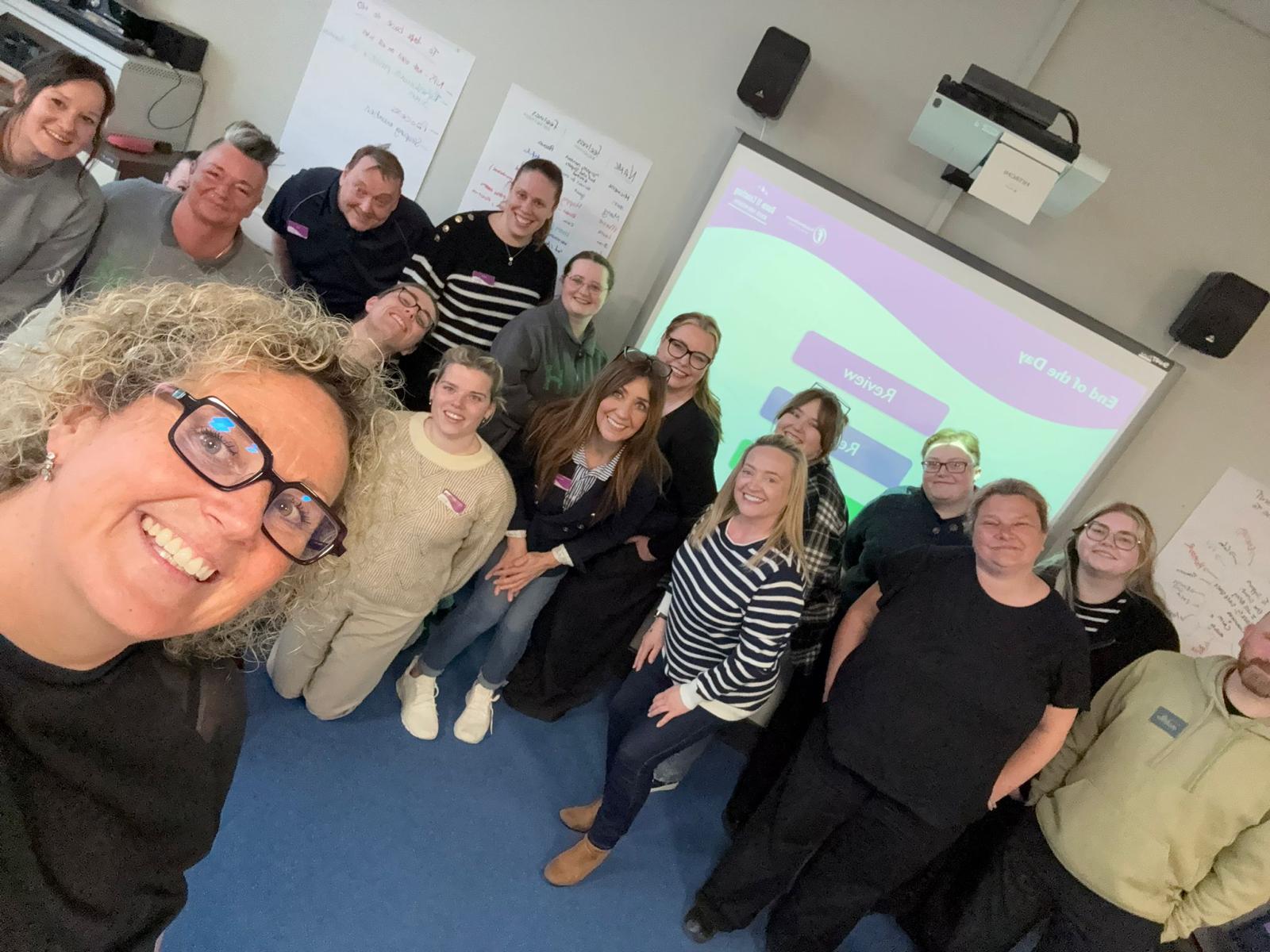Anna with a group of participants during a customer-care training session.